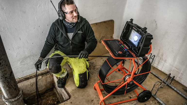 Operator carrying out internal pipe renewal with specialized equipment