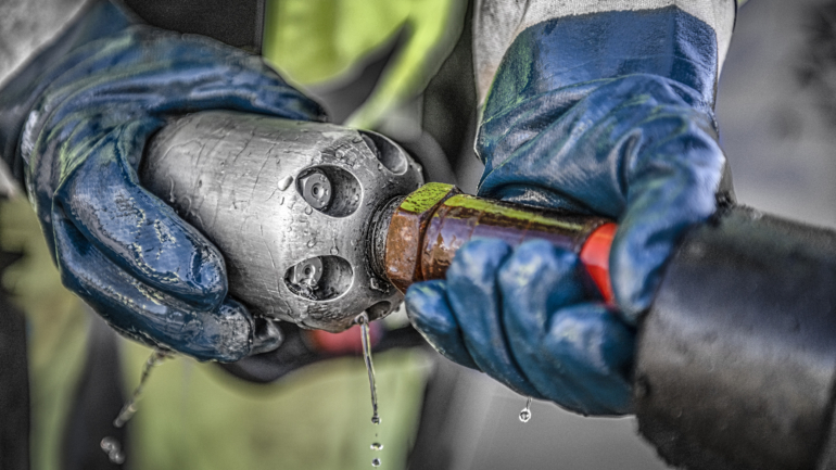 Preparing a high-pressure flushing nozzle for pipe cleaning.