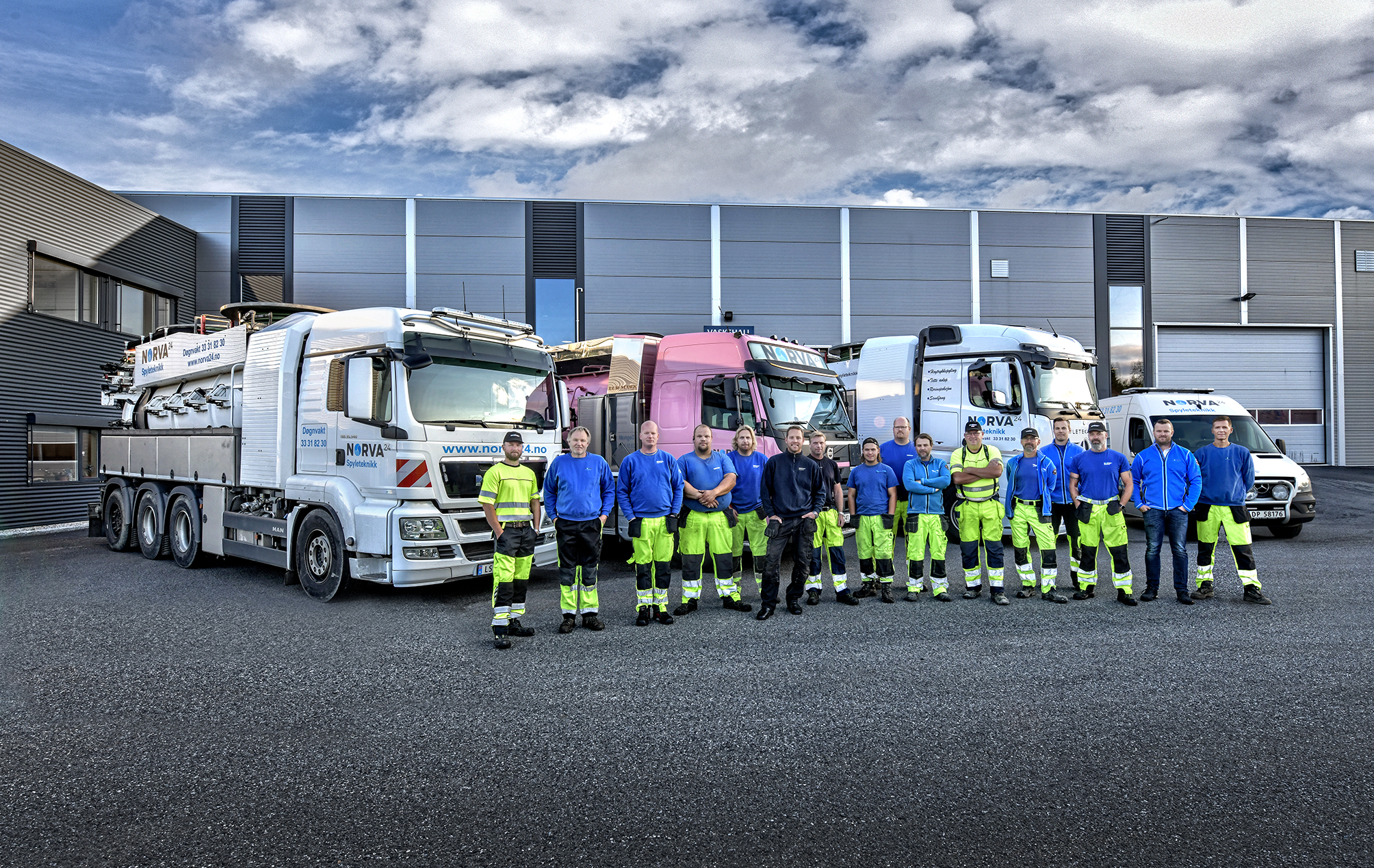 Norva24 team in front of a fleet of infrastructure maintenance vehicles.
